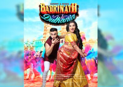 A man and woman dancing, with "Badrinath Ki Dulhania" and colorful background.