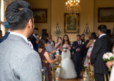 The groom's view of the bride and her father walking down the aisle.