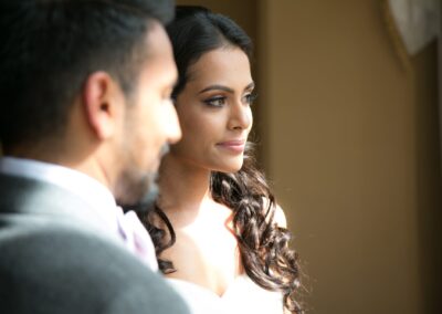 A close-up of the bride looking into the distance, with the groom's shoulder in foreground.
