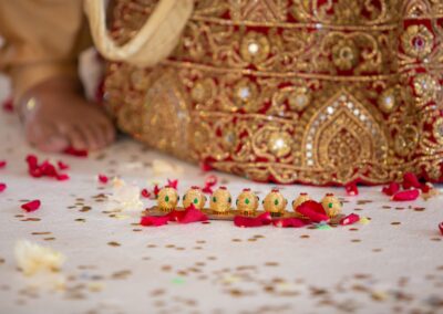 Decorative elements on the floor, including rose petals and tiny golden vessels.