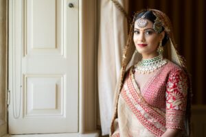 A stunning bride in traditional attire looks towards the camera.