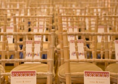 Wedding ceremony chairs with welcome cards for guests.