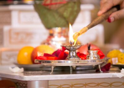Lighting a sacred lamp during Hindu wedding ritual.