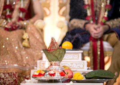 Hindu wedding altar with offerings, coconut and sacred flame.