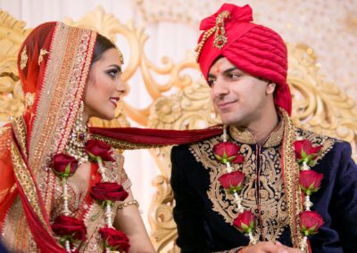 Bride and groom exchanging loving gaze in traditional attire.