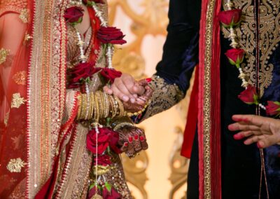 Bride and groom holding hands during Hindu wedding ceremony.