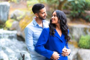 A couple embracing outdoors, looking lovingly into each other's eyes.